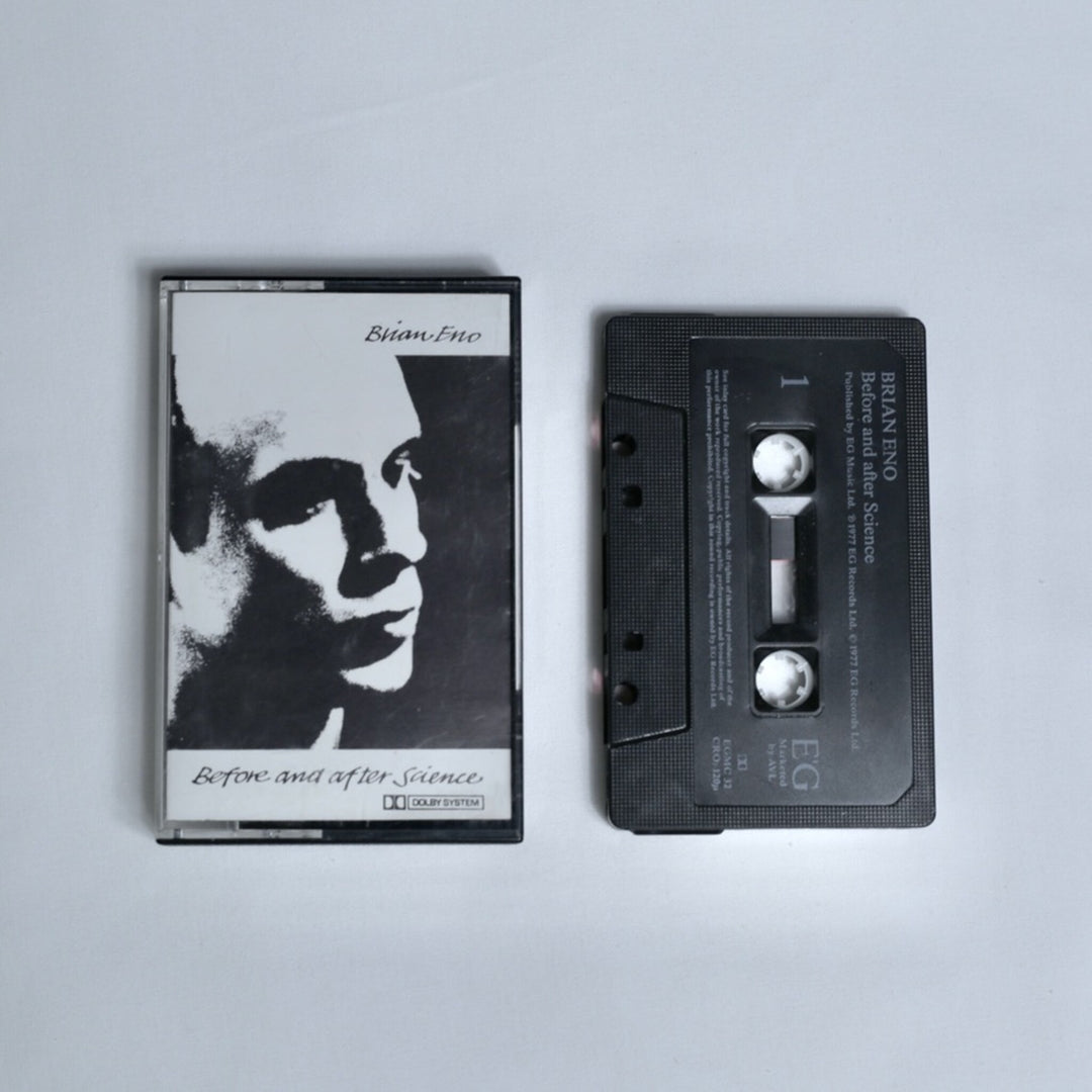 Brian Eno – Before and After Science cassette tape, black and white portrait cover art with Dolby System branding, shown alongside the cassette