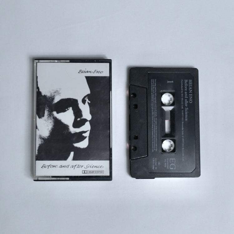 Brian Eno – Before and After Science cassette tape, black and white portrait cover art with Dolby System branding, shown alongside the cassette