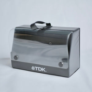 TDK cassette case on a light gray background