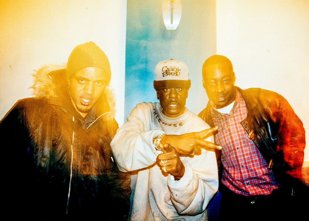 Three men posing at a nightclub with soft blur 