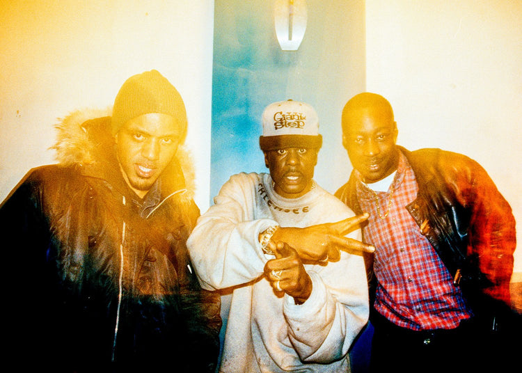 Three men posing at a nightclub with soft blur 