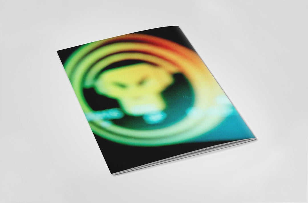 Back of a book with colourful spiral design on an off white background.