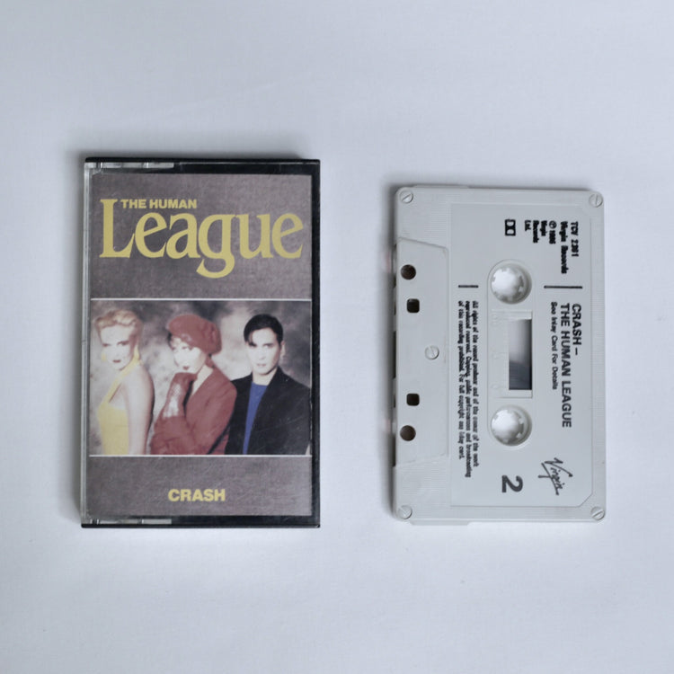The Human League – Crash cassette tape, cover photo of the three band members, shown alongside the white cassette (Side 2)