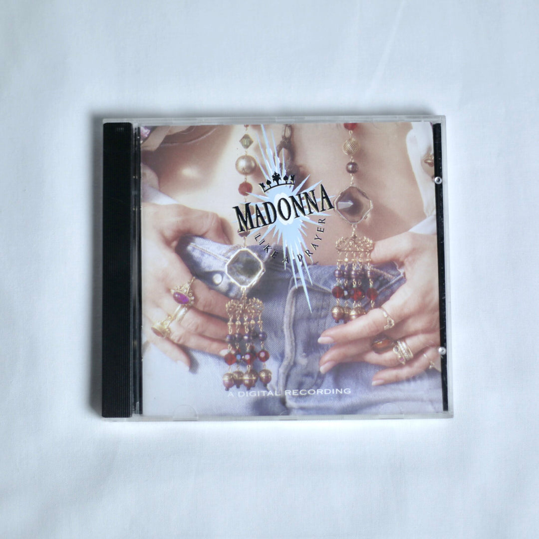 CD cover with 'Madonna' and 'Like a Prayer' on a white background