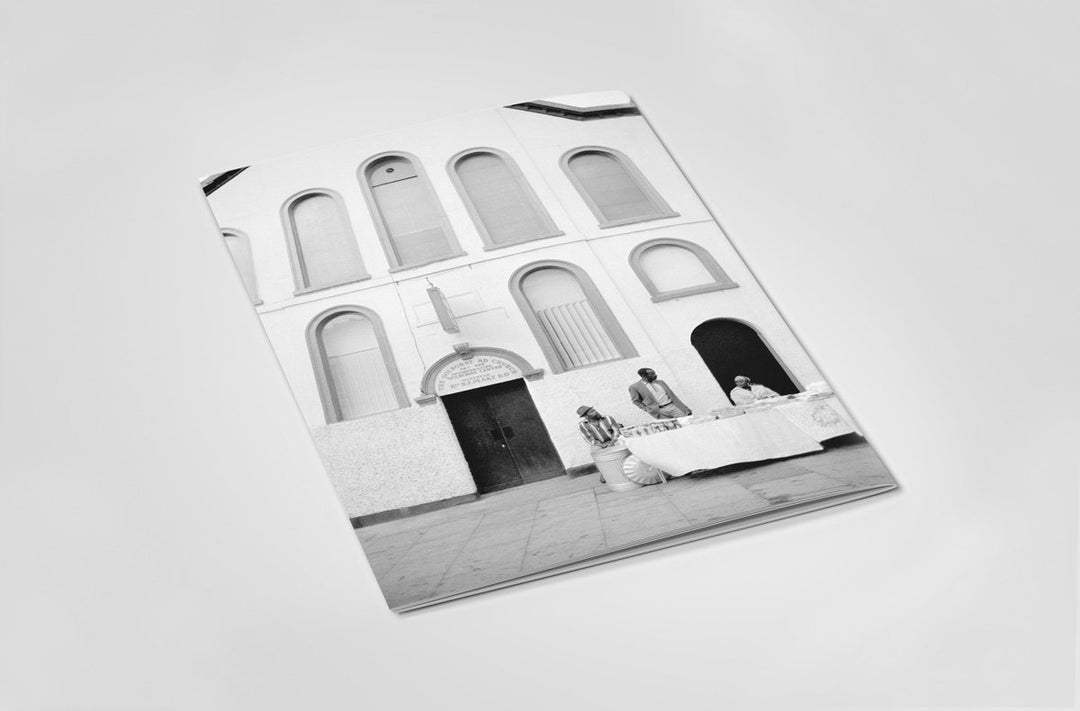 Back cover of Black and white photography book with Notting Hill building with people in front on a light gray background