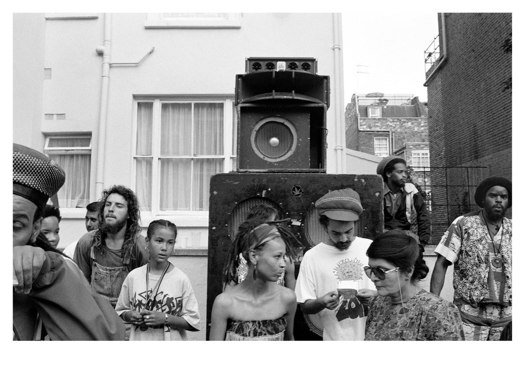 Black and white photo of a group of people with large speakers at Notting Hill Carnival