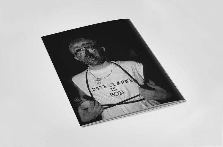 Back of book with a black and white photo of a person wearing a shirt with 'Dave Clarke is God' text.