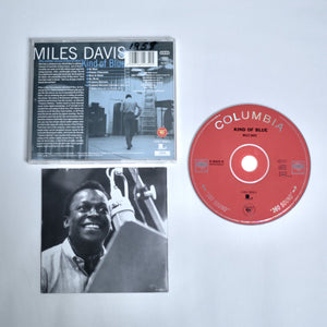 Miles Davis 'Kind of Blue' album with cover and red disc on a off white background