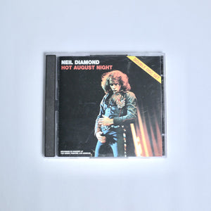 CD cover of 'Hot August Night' by Neil Diamond on an off white background