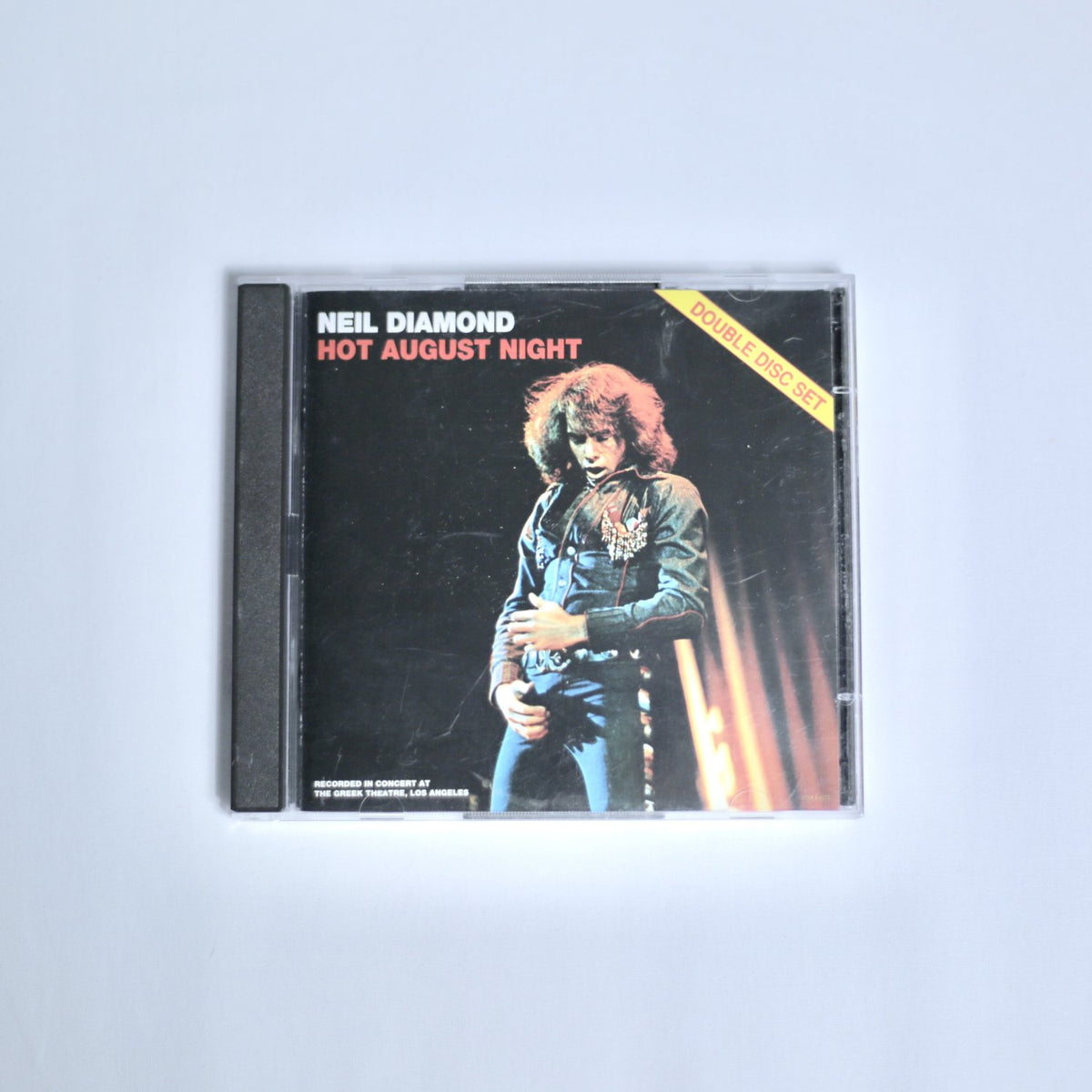 CD cover of 'Hot August Night' by Neil Diamond on an off white background