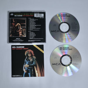 Neil Diamond's 'Hot August Night' dual CDs on an off white background