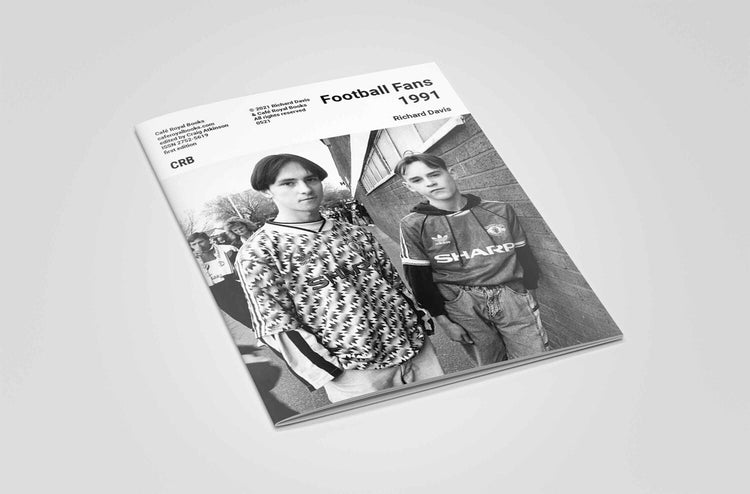 Book titled 'Football Fans 1991' with black and white photo of two football fans on an off white background