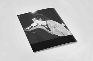 Back book cover with a black and white photo of a singer on the cover, on a light gray background