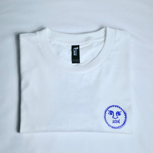 White t-shirt with a blue logo on an off white background