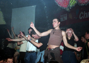 People dancing at a rave with a dark background
