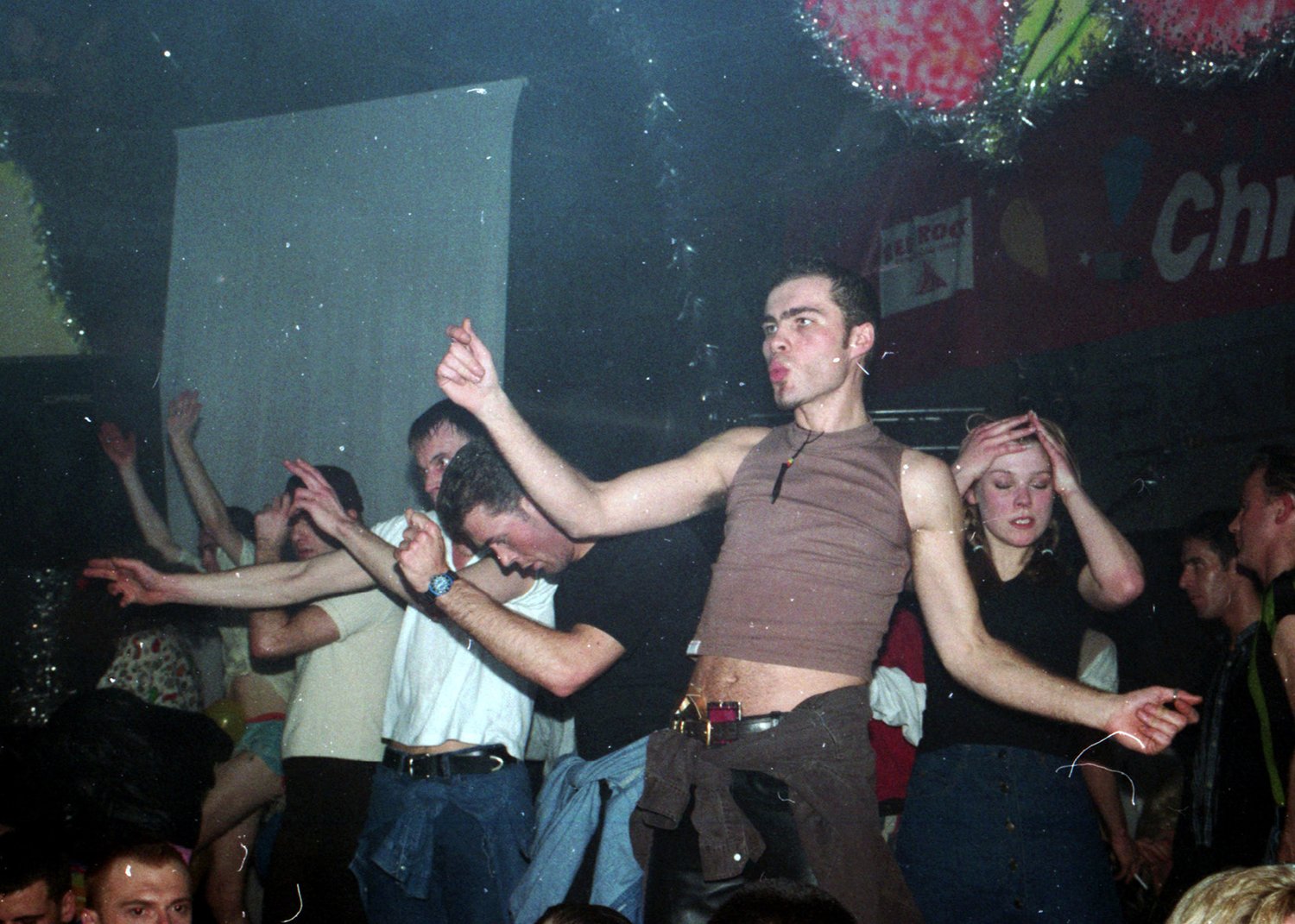 People dancing at a rave with a dark background