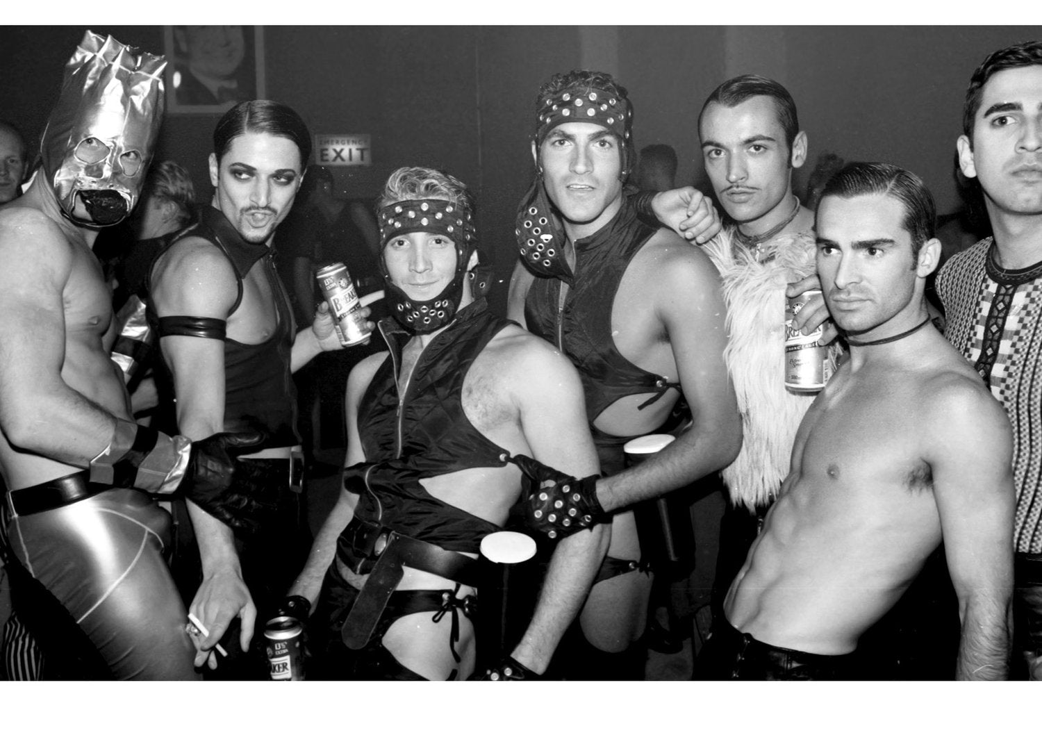 Group of men in costumes and leather posing together.