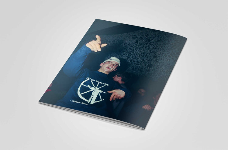 Back of book with a person wearing a blue shirt at a rave against a dark background