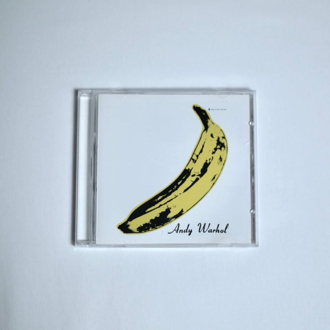 Velvet Undergound CD with a yellow banana design by 'Andy Warhol' text on an off white background
